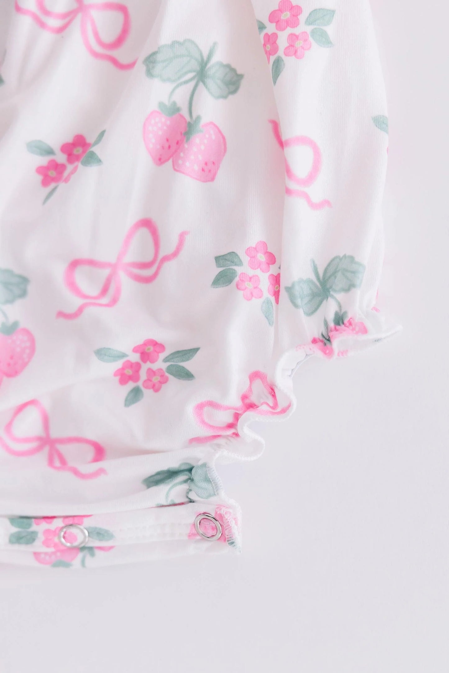 BERRIES & BOWS RUFFLE CROSS BACK ROMPER